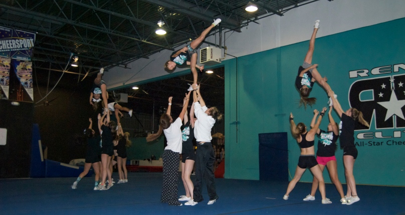 RENO, NEVADA - October 20, 2014: The entire Reno Elite Black team performs a stunt sequence together.  This team is coached by Reno Elite's owner JoAnn Bryant.